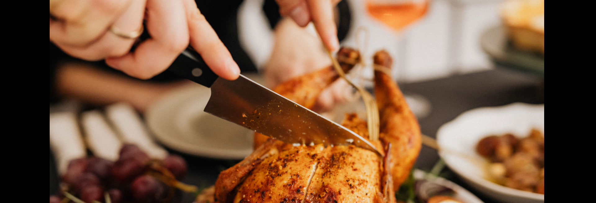 An image of a chicken being carved for a celebratory meal